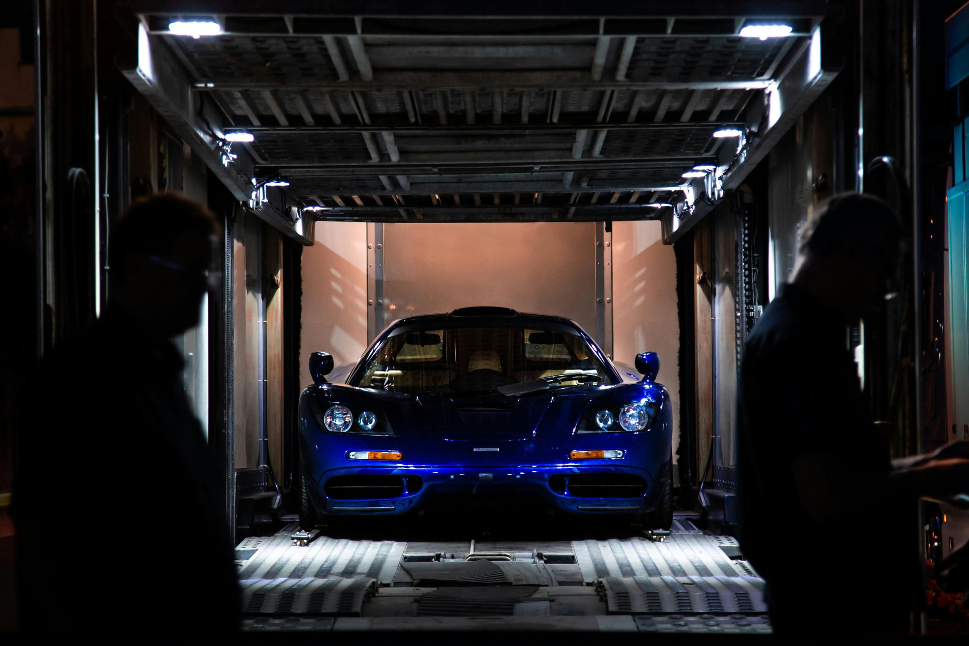 McLaren F1 inside lit enclosed sea freight container