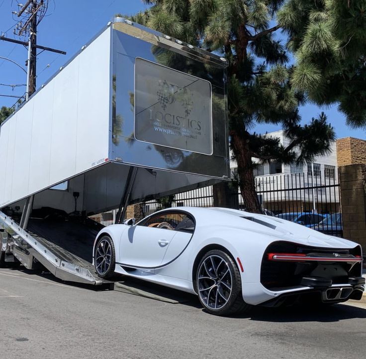 Bugatti Chiron being loaded into enclosed transport trailer